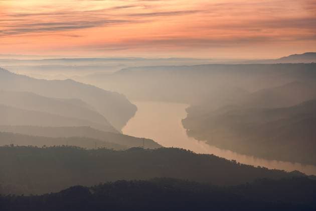 Creative Highlights World Drone view of picturesque scenery with bright sunset sky over foggy river and hills in Almatret HiCarles_ID12666_384784_003 Copyright: xHixCarlesx Model Released