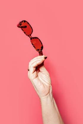 Unrecognizable person demonstrating sunglasses against pink background in studio, Model released HodeiUnzueta_ID12646_384366_007 Copyright: xHodeixUnzuetax MR