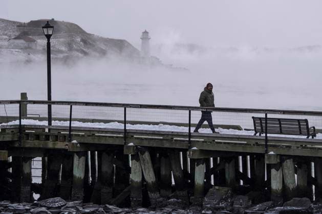 February 4, 2023, Halifax, NS, Canada: A man walks on the waterfront as sea smoke, or ice fog, forms in Halifax Harbour on Saturday, February 4, 2023. Environment Canada has warned of windchill values between -30 C and -40 C across the Maritimes as an Arctic air mass moves across the region. Halifax Canada  - ZUMAc35_ 20230204_zaf_c35_007 Copyright: xDarrenxCalabresex