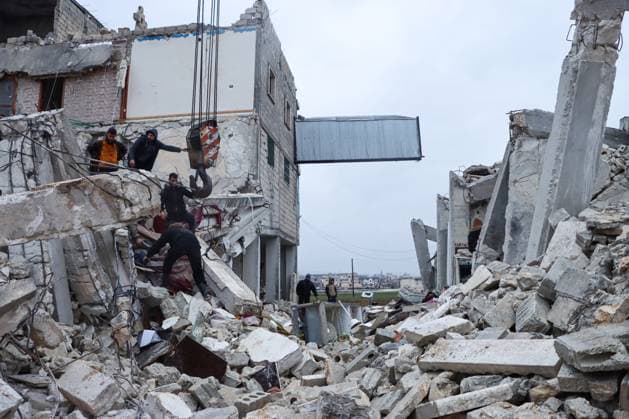 Rescue teams search for victims in the rubble following an earthquake in northwestern Syrian Idlib in the rebel-held part of Idlib province, on February 6, 2023. - Hundreds have been reportedly killed in Turkey and Syria after a 7.8-magnitude earthquake that originated in Turkey and was felt across Middle East countries.  SYR2023020610 SyriaxCivilxDefense