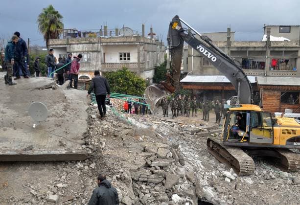 (230206) -- JABLEH (SYRIA), Feb. 6, 2023 -- Rescuers work among the rubble of a building destroyed in a powerful earthquake in the city of Jableh, Latakia province, Syria, on Feb. 6, 2023. According to the Syrian health ministry and the Britain-based pro-rebel Syrian Observatory for Human Rights, a 7.7-magnitude earthquake jolted the northern Syrian provinces of Latakia, Tartous, Hama, Aleppo and Idlib on Monday, killing at least 870 and injuring 1,326. (Str Xinhua) SYRIA-LATAKIA-JABLEH-EARTHQUAKE-RESCUE Stringer 