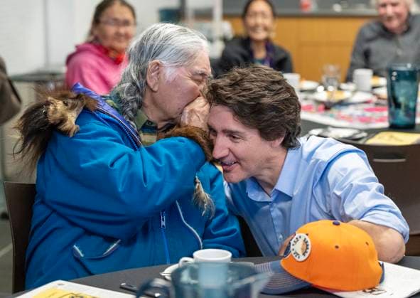 February 12, 2023, Whitehorse, YT, CANADA: Randall Tetlichi whispers his age to Prime Minister Justin Trudeau at the elders tea during Council of Yukon First Nations Together Today For Our Children Tomorrow 50th Anniversary celebrations at the Kwanlin DoÂ¼n Cultural Centre in Whitehorse, Yukon on Sunday February 12, 2023. Whitehorse CANADA  - ZUMAc35_ 20230212_zaf_c35_016 Copyright: xMikexThomasx