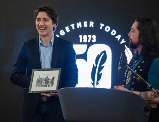 February 12, 2023, Whitehorse, YT, CANADA: Grand Chief Peter Johnston watches as Prime Minister Justin Trudeau reacts to be given a framed archival photo of his father Pierre and brother Sasha playing on a swing set in Old Crow, Yukon, back in the early 1970s at a dinner event during Council of Yukon First Nations Together Today For Our Children Tomorrow 50th Anniversary celebrations at the Kwanlin DoÂ¼n Cultural Centre in Whitehorse, Yukon on Sunday February 12, 2023. Whitehorse CANADA  - ZUMAc35_ 20230212_zaf_c35_019 Copyright: xMikexThomasx