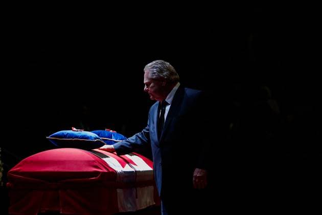 February 14, 2023, MISSISSAUGA, ON, CANADA: Premier of Ontario Doug Ford puts his hand on the casket of former Mississauga mayor Hazel McCallion during her state funeral in the Paramount Fine Foods Centre in Mississauga, Ontario, Tuesday, Feb.14, 2023. MISSISSAUGA CANADA  - ZUMAc35_ 20230214_zaf_c35_039 Copyright: xColexBurstonx