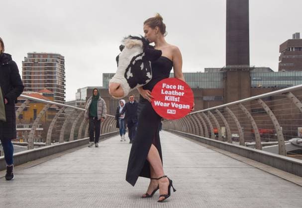 February 16, 2023, London, United Kingdom: PETA (People for the Ethical Treatment of Animals) staged a ˜catwalk™ on Millennium Bridge on the eve of London Fashion Week with a model wearing an outfit with a faux cow™s head and holding a placard which states Leather kills, wear vegan . The stunt aims to inspire people to ditch animal leather and references Schiaparelli™s ˜animal heads™ which caused much controversy recently at Paris Fashion Week. London United Kingdom - ZUMAs197 20230216_zaa_s197_353 Copyright: xVukxValcicx