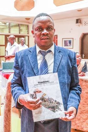 February 16, 2023, Nakuru, Kenya: Betterman Simidi Musasia, founder and patron of Kenyan nonprofit Clean Up Kenya Organization poses for a photo while holding the report dubbed Trashion, the stealth export of waste plastic clothes to Kenya that detailed how second hand clothes from European countries are turning out to be garbage after its launch. An investigation by Kenyan nonprofit environmental group Clean-Up Kenya and Wild light for the Changing Markets Foundation found that European countries are dumping 37 million items of unusable plastic clothing in Kenya every year. The investigation found that more than one in three pieces of used clothing shipped to Kenya are of substandard quality and immediately the bails are opened, they be - ZUMAs197 20230216_zab_s197_045 Copyright: xJamesxWakibiax