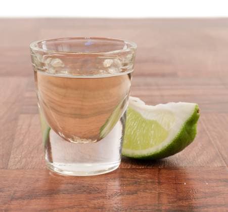 tequila shot on a bar top with a lime wedge Copyright: xcharlesxwollertzx xDesignxPicsx , 31929957  Copyright: MarinaxGlebovax xDesignxPics 31929957