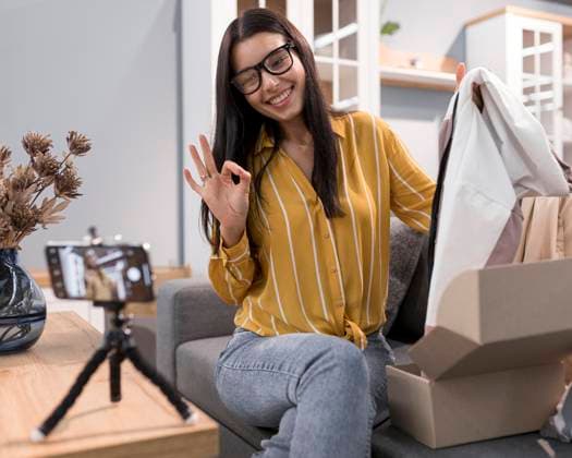 vlogger home unboxing clothes with smartphone vlogger home unboxing clothes with smartphone Copyright: xZoonar.com OleksandrxLatkunx 18767243 ,model released, Symbolfoto ,property released