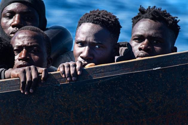 February 21, 2023, SAR Italy, Italy: A man stares blankly from a precarious metal boat carrying 40-50 migrants across the Mediterranean from Africa. At around 7:30 a.m. on Tuesday 21 February, 44 and a half miles off Lampedusa, 40 sub-Saharan migrants were rescued from a precarious metal boat. There were 20 minors on board, 18 of whom were unaccompanied by adults. SAR Italy Italy - ZUMAs197 20230221_zaa_s197_272 Copyright: xXimenaxBorrazasx
