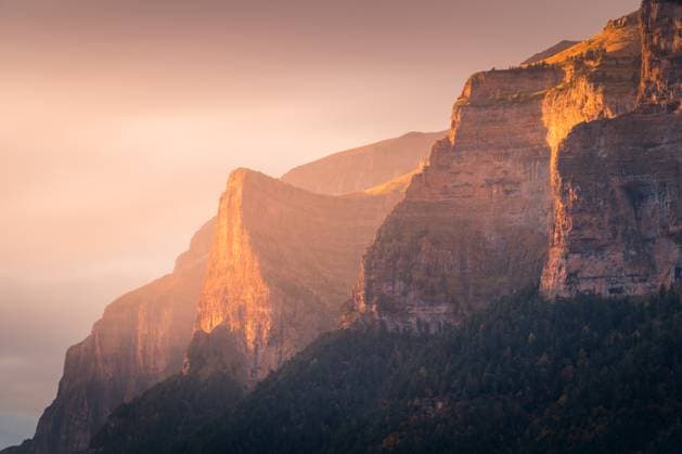 Amazing scenery of rocky mountains covered with autumn trees on sunny day in Ordesa y Monte Perdido National Park JavierMartinez_ID12785_387852_019 Copyright: xJavierxMartinezx Model Released