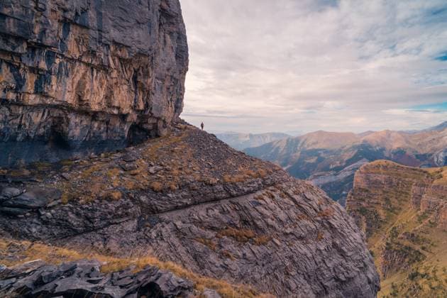Scenic view of distant traveler standing on rough rocky mountain slope in Ordesa y Monte Perdido, Model released JavierMartinez_ID12785_387866_029 Copyright: xJavierxMartinezx MR