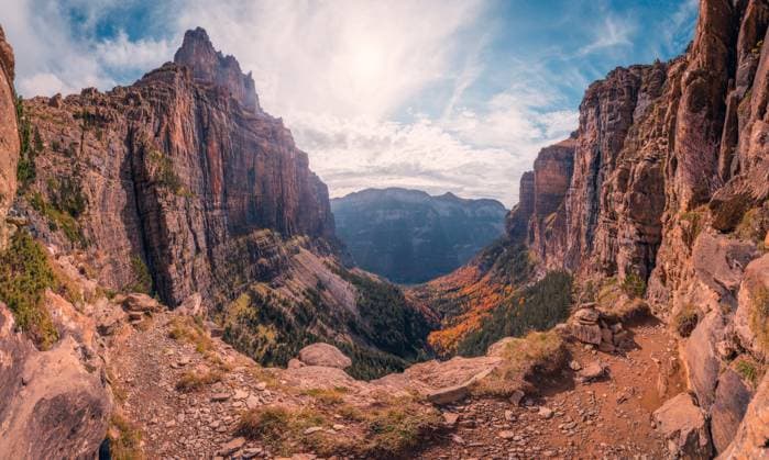 Picturesque view of rough rocky mountains covered with trees on cloudy sunny day in Ordesa y Monte Perdido National Park JavierMartinez_ID12785_387902_061 Copyright: xJavierxMartinezx Model Released