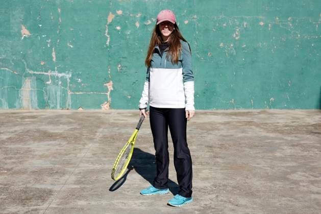 Creative Highlights Symbolbilder Positive female athlete in sportswear and cap with tennis racket smiling and looking at camera against shabby wall, Model released LauraLibran_ID12931_392808_001 Copyright: xLauraxLibranx MR