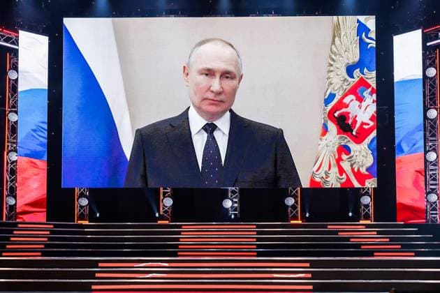 RUSSIA, MOSCOW - FEBRUARY 23, 2023: Russia s President Vladimir Putin (on screen) addresses Russian citizens via a video link during a concert at the Central Academic Theatre of the Russian Army on Defender of the Fatherland Day. Vadim Savitsky Russian Defence Ministry TASS  57519788