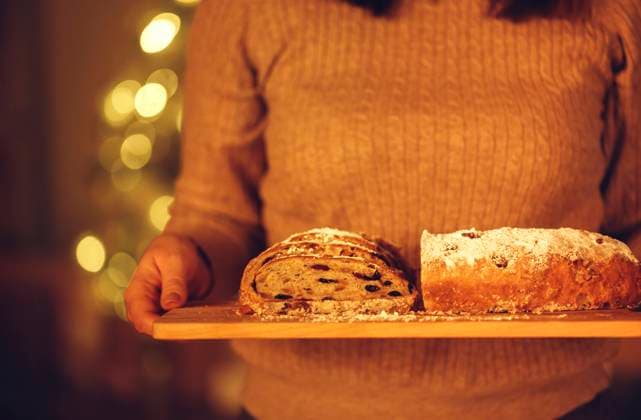 Cropped shot of woman holding delicious freshly baked homemade Christmas pie while standing against blurred xmas tree in background Cropped shot of woman holding delicious freshly baked homemade Christmas pie while standing against blurred xmas tree in background, preparing food for New Years Eve, selective focus on cake in hands. Stollen Copyright: xZoonar.com DashaxPetrenkox 18978443