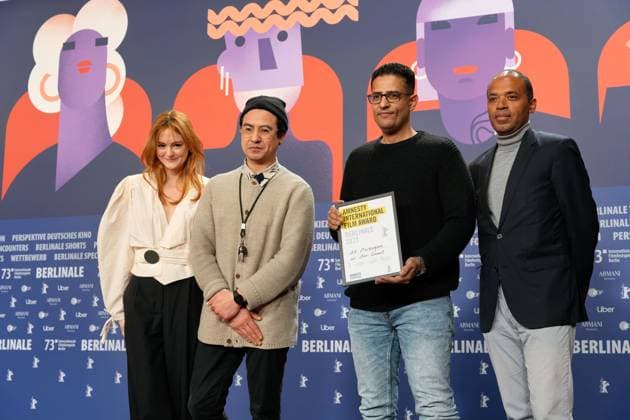 25 02 2023,Berlin,Germany,73 Berlin International Film Festival Director Amr Gamal is awarded the Amnesty Film Prize for his film Al Murhaqoon by Amnesty Jury Members Lea van Acken, Burhan Qurbani and Markus N Beeko.