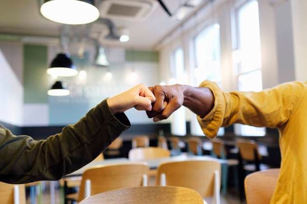 Hands of business colleagues giving fist bump at office model released, Symbolfoto property released, ASGF03301