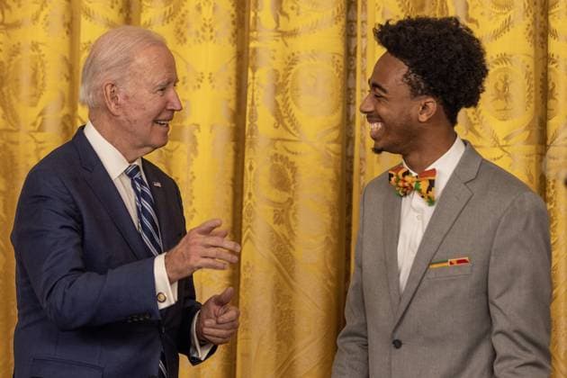 President Joe Biden chats with DuWayne Portis Jr. after delivering remarks at reception celebrating Black History month in the East Room of the White House in Washington, D.C. on Monday, February 27, 2023.  WAP2023027008 TASOSxKATOPODIS