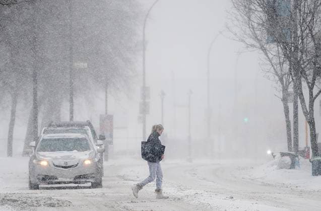 News Bilder des Tages February 28, 2023, Montreal, PQ, Canada: A woman crosses a street during a snowstorm in Montreal, Tuesday, Feb. 28, 2023. Montreal Canada  - ZUMAc35_ 20230228_zaf_c35_008 Copyright: xGrahamxHughesx