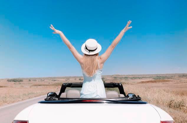 Happy woman sitting on passenger seat in car Back view of joyful young female in summer clothes in cabriolet during road trip Copyright: xZoonar.com DashaxPetrenkox 16727882 ,model released, Symbolfoto ,property released