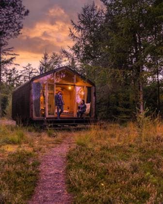 couple on a trip in the nature at a wooden hut in autumn forest in the Netherlands, cabin off grid Wooden hut in an autumn forest in the Netherlands, cabin off the grid, wooden cabin, and red fall trees. couple men and Asian women in a cabin in the woods during vacation nature trekking fall season Copyright: xZoonar.com FOKKExBAARSSENx 19594214 ,model released, Symbolfoto ,property released