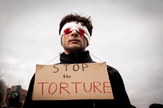 Global Women™s March for Iran in Washington, DC A man in a (faux) bloodied blindfold calls for an end to the torture of Iranian prisoners during a protest against the Islamic regime of Iran, part of a day of women™s marches around the world. The costume specifically refers to rapper Toomaj Salehi, who was photographed in a bloody blindfold after arrest. National Solidarity Group of Iran hosted the event, which featured prominent Iranian-American women in a protest joined by members of US-Ukrainian Activists. Protesters continue to demand an end to the poisoning of schoolgirls, curtailment of nuclear negotiations, and the fall of the Islamic regime. Washington DC United States  Copyright: xAllisonxBaileyx originalFilename: bailey-globalwo230311_nplqI.jpg