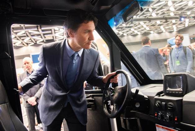 March 13, 2023, Montreal, PQ, Canada: Prime Minister Justin Trudeau looks into the cabin of an electric utility truck during a visit to Impulsion, the International Summit on Electric and Smart Transportation, in Montreal, Monday, March 13, 2023. Montreal Canada  - ZUMAc35_ 20230313_zaf_c35_008 Copyright: xGrahamxHughesx