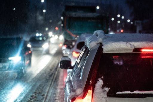 RECORD DATE NOT STATED A row of cars driving on a snow-covered road at night illuminated by their headlamps, creating a trail of light in the darkness *** einer reihen des Autos fahrend am einer Schnee Gedeckter Verkehrsstrasse im Nacht beleuchtet indem ihrem headlamps, schöpfende einer Fährte des Licht ÊIn der Dunkelheit 13083682