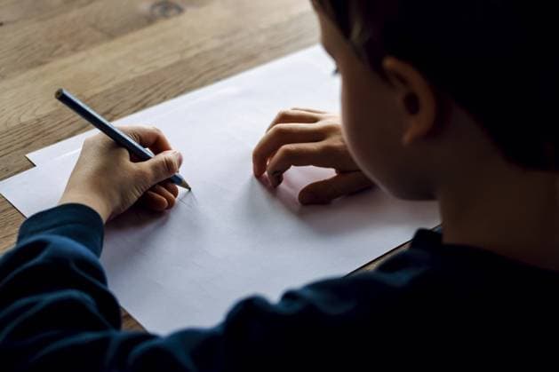 Symbolfoto zum Thema Linkshaender: Ein fuenfjaehriger Junge sitzt zu Hause und schreibt mit einem Bleistift in der linken Hand auf ein Blatt Papier. Berlin, 14.03.2023 Berlin Deutschland *** Left-handed symbol photo A five-year-old boy sits at home writing on a piece of paper with a pencil in his left hand Berlin, 14 03 2023 Berlin Germany Copyright: xThomasxTrutschel photothek.dex