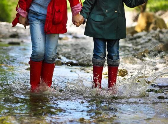 Child wearing rain boots jumping. Close up Children wearing rain boots jumping into a mountain river. Close up ,model released, Symbolfoto Copyright: xZoonar.com DashaxPetrenkox 7311390 ,model released, Symbolfoto ,property released