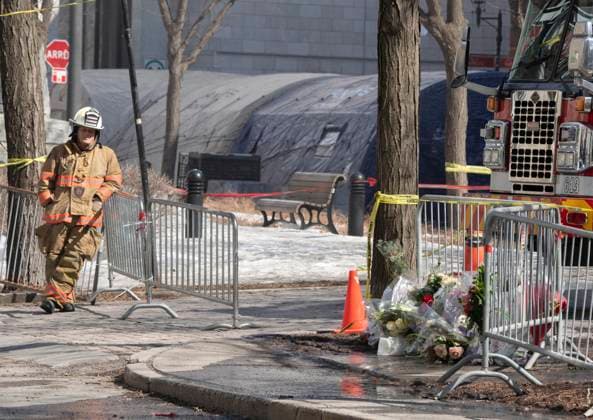 March 20, 2023, Montreal, PQ, Canada: A firefighter takes a break near a makeshift memorial as the search for victims continues Monday, March 20, 2023 at the scene of last weeköÄÃ s fire that left one person dead and six people missing in Montreal. Montreal Canada  - ZUMAc35_ 20230320_zaf_c35_012 Copyright: xRyanxRemiorzx
