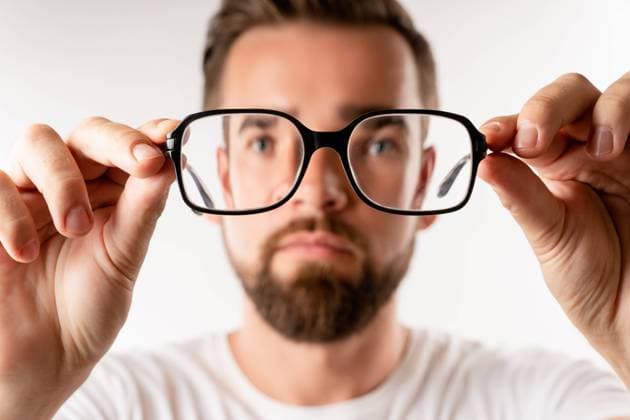 Young man holding eyeglasses in his hands Young man holding eyeglasses in his hands on white background ,model released, Symbolfoto Copyright: xZoonar.com blackdayx 18594472 ,model released, Symbolfoto ,property released