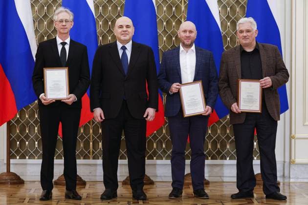 RUSSIA, MOSCOW - MARCH 24, 2023: Igor Gashkov, restorer at the Kizhi Federal Museum of Cultural History and Architecture, Russia s Prime Minister Mikhail Mishustin, Alexei Chusov, Head of the Zaonezhye Architectural Restoration Centre, and Andrei Kovalchuk (L-R), lead expert at Rakhmanov Centre for Preservation of Wooden Architecture under the Kizhi Federal Museum, pose during a ceremony at the House of the Government to present national awards in the field of culture for 2022. Dmitry Astakhov POOL TASS  58044859