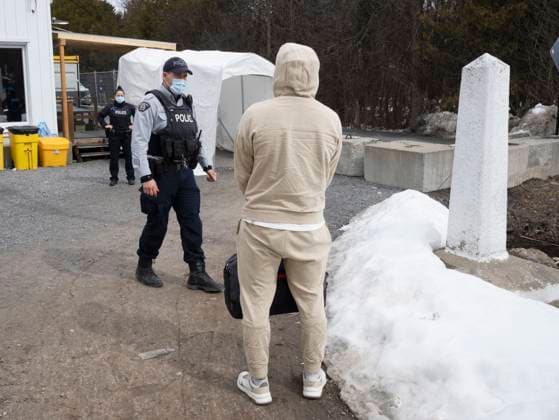 March 24, 2023, Champlain, New York, United States: An asylum seeker from Afghanistan prepares to cross the border at Roxham Road from New York into Canada on Friday March 24, 2023 in Champlain, N.Y. Champlain United States  - ZUMAc35_ 20230324_zaf_c35_124 Copyright: xRyanxRemiorzx