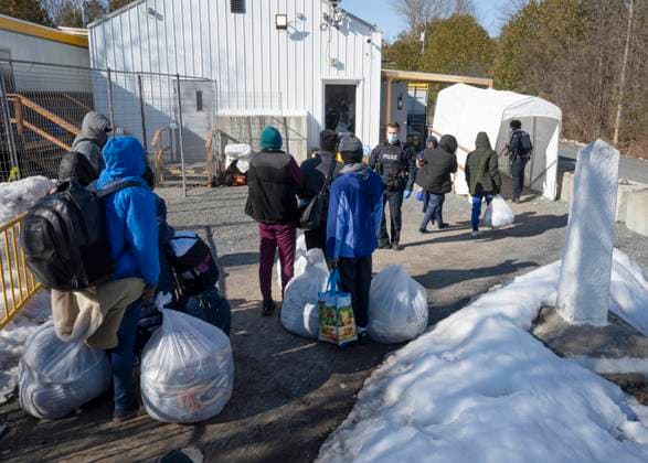 March 24, 2023, Champlain, New York, United States: Asylum seekers cross the border at Roxham Road from New York into Canada on Friday, March 24, 2023 in Champlain, N.Y. The irregular border crossing will be closed permanently tonight at midnight. Champlain United States  - ZUMAc35_ 20230324_zaf_c35_207 Copyright: xRyanxRemiorzx