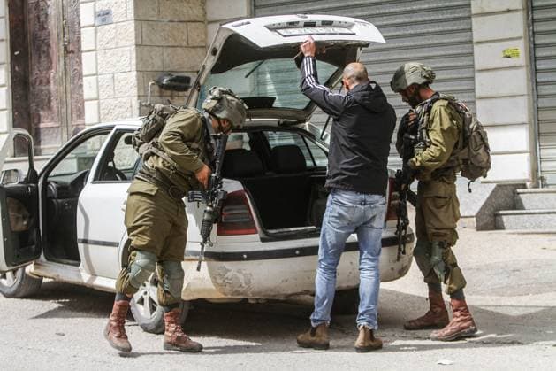 News Themen der Woche KW12 News Bilder des Tages March 26, 2023, Nablus, West Bank, Palestine: Israeli soldiers search Palestinian cars, after a shooting attack on two Israeli soldiers, in the town of Hawara, south of Nablus, in the occupied West Bank. Unrest between Palestinians, Jewish settlers, and Israeli soldiers in the town of Hawara, After the settlers called for a crackdown on Palestinians after a Palestinian opened fire at a military post and injured two Israeli soldiers. This is the third shooting attack in the town this month. Nablus Palestine - ZUMAs197 20230326_zaa_s197_006 Copyright: xNasserxIshtayehx