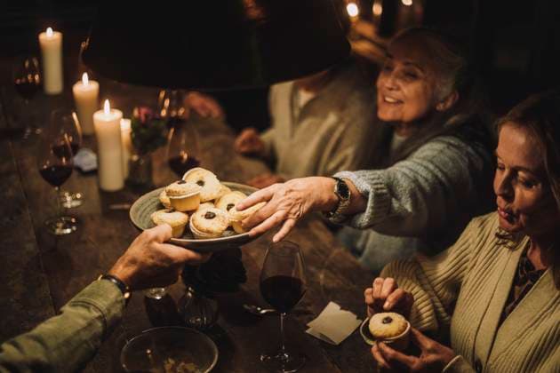 Senior woman taking cupcake from plate during dinner party Sweden, Stockholm, model released, property released Copyright: xMaskotx , MA100176 MA100176