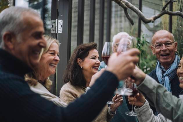 Cheerful retired male and female friends toasting drinks at dinner party Sweden, Stockholm, model released, property released Copyright: xMaskotx , MA100200 MA100200