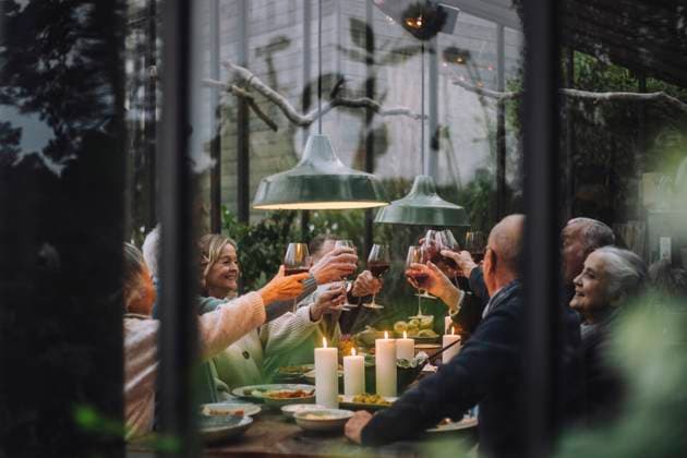 Happy senior male and female friends toasting wine during dinner party in backyard Sweden, Stockholm, model released, property released Copyright: xMaskotx , MA100225 MA100225