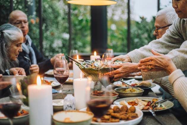 Senior woman serving salad to male and female friends during party Sweden, Stockholm, model released, property released Copyright: xMaskotx , MA100229 MA100229