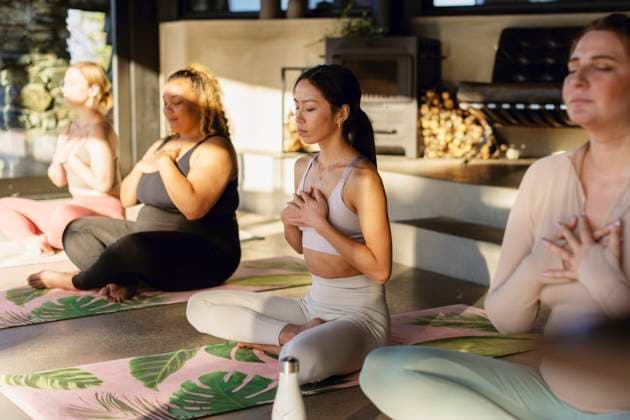 Female friends with hands on chest exercising together at retreat center Sweden, Stockholm, model released, property released Copyright: xMaskotx , MA100385 MA100385