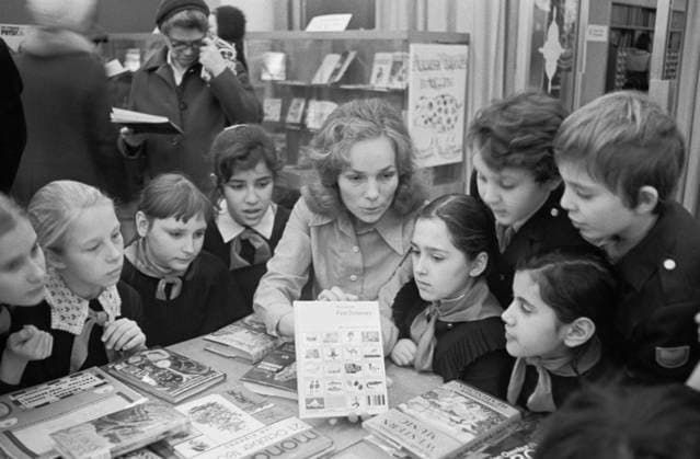 November 1-20, 1976. Moscow, USSR. English teacher at School No. 46 with her students observe the Exhibition of English Children Books in Moscow House of Books. The exact date of the photograph is unknown. Igor Zotin TASS  17200511