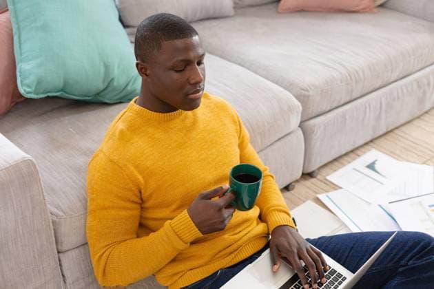 African american man using laptop sitting on floor working at home and drinking coffee African american man using laptop sitting on floor working at home and drinking coffee. Inclusivity, domestic life, positivity and working remotely., model released, , property released, Cape Town, South Africa, 2022-06-01T22:00:00.000Z, 3774176.jpg, people,african american,man,using laptop,sitting,floor,working home,drinking coffee,inclusivity,domestic life,positivity,remotely,room,interior,expressing,indoors,home,wireless technology,wall,apartment,indoor,laptop,working at home,home interior,furniture,smiling,sofa,house,living,inside,desk,casual,african,american,using,working,drinking,coffee,domestic,life Young Adult,Man,Male,Black