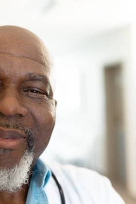 Vertical half face portrait of smiling senior african american male doctor, with copy space Vertical half face portrait of smiling senior african american male doctor, with copy space. Hospital, medical and healthcare services., model released, , property released, Cape Town, South Africa, 2022-10-21T22:00:00.000Z, 3876644.jpg, people,vertical,half face,face portrait,smiling,senior,african american,male doctor,copy space,hospital,medical,healthcare,service,medicine,doctor,clinic,care,health,patient,treatment,illness,disease,nurse,occupation,professional,successful worker,stethoscope,virus,half,face,portrait,african,american,male,copy,space Senior,Elderly,Man,Male,Black