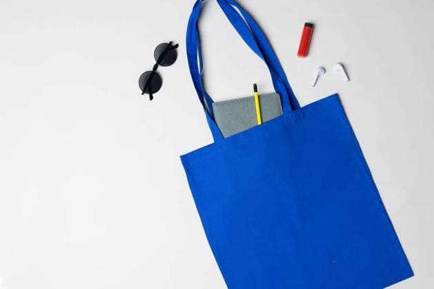 High angle view of blue canvas bag with notebook, sunglasses, earphones and lighter, copy space High angle view of blue canvas bag with notebook, sunglasses, earphones and lighter, copy space. Bags and fashion concept., model released, , property released, Cape Town, South Africa, 2023-03-15T22:00:00.000Z, 4002332.jpg, high angle,angle view,blue,canvas,bag,notebook,sunglass,earphone,lighter,copy space,fashion,concept,design,background,abstract,style,illustration,modern,white,business,graphic,art,color,beautiful,pattern,texture,symbol,beauty,technology,sky,creative,isolated,high,angle,view,copy,space