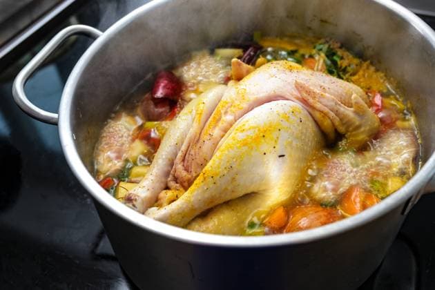 Chicken soup with vegetables and spices is boiling in a pot, cooking a healthy broth, home remedy against cold and flu, selected focus Chicken soup with vegetables and spices is boiling in a pot, cooking a healthy broth, home remedy against cold and flu, selected focus, narrow depth of field Copyright: xZoonar.com MARENxWINTERx 19500774
