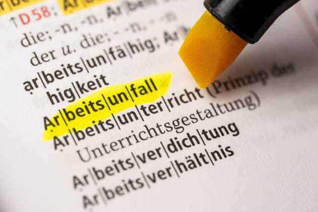 Bavaria, Germany - 2 April 2023: The word industrial accident marked with a highlighter in a German dictionary Duden. Meaning, language and definition concept *** Das Wort Arbeitsunfall mit einem Textmarker in einem deutschen Wörterbuch Duden markiert. Bedeutung, Sprache und Definition Konzept