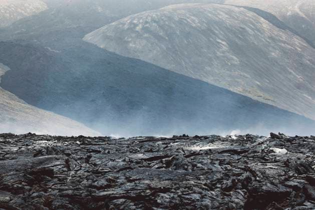 Steam coming of still hot lava rocks from 2022 Meradalir erruption - Iceland Geldingadalir active Volcano, errupting in 2021 - Fagradalsfjall and 2022 -Meradalir. Still hot lava rocks, steam comping up from the grounds. Dark grey, black volcanic rocks in Iceland. Dramatic view of lava rocks cold cloudy autumn day in Iceland. Copyright: xZoonar.com ZigaxPlahutarx 19561750