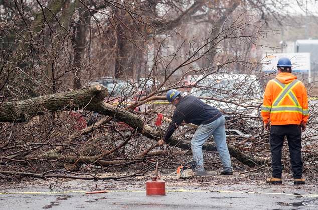 April 6, 2023, Montreal, PQ, Canada: Workers clear a fallen tree from a street following an ice storm in Montreal, Thursday, April 6, 2023. Montreal Canada  - ZUMAc35_ 20230406_zaf_c35_008 Copyright: xGrahamxHughesx