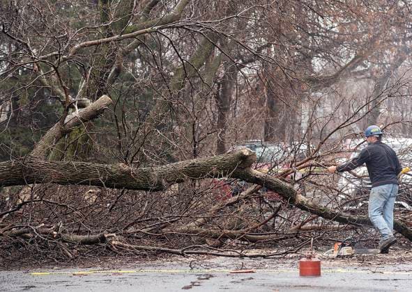 April 6, 2023, Montreal, PQ, Canada: Workers clear a fallen tree from a street following an ice storm in Montreal, Thursday, April 6, 2023. Montreal Canada  - ZUMAc35_ 20230406_zaf_c35_009 Copyright: xGrahamxHughesx